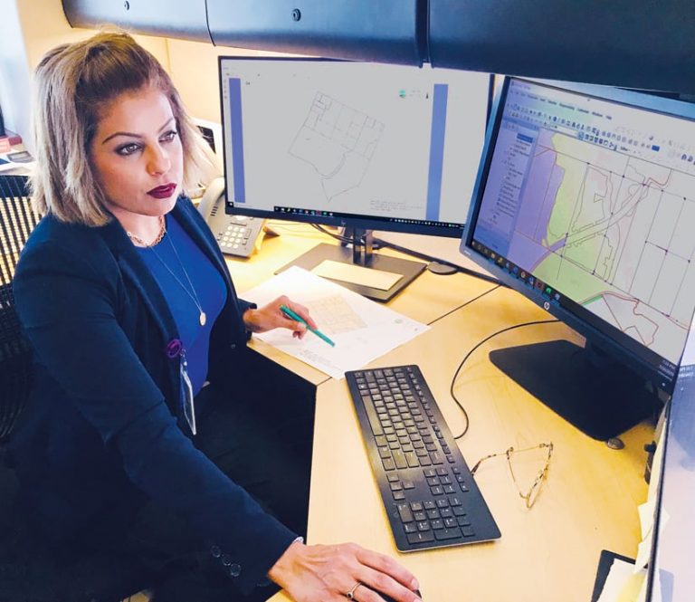 An analyst using GIS on a computer