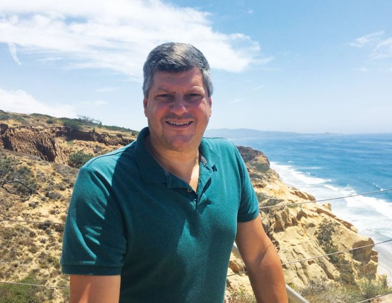 A photo of Arthur Lembo on a beachside cliff