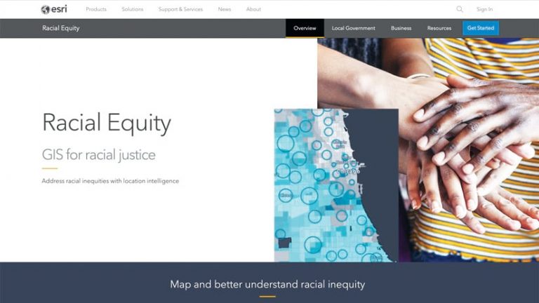 A screenshot of the gateway to Esri’s racial equity website, showing a map and a photo of people’s hands stacked on top of one another