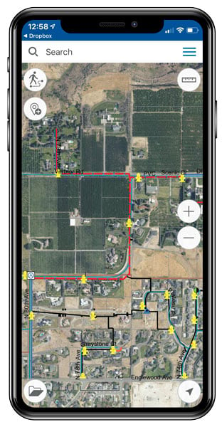 A smartphone showing an imagery-based map with a red line on it that indicates a water main that needs to be replaced