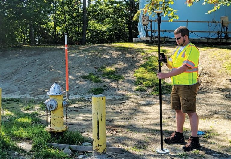 Fieldworker collecting data near a fire hydrant