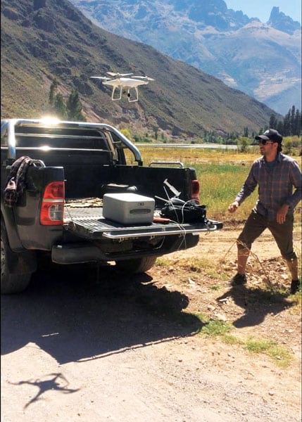 A team member flying a UAV out of a truck bed