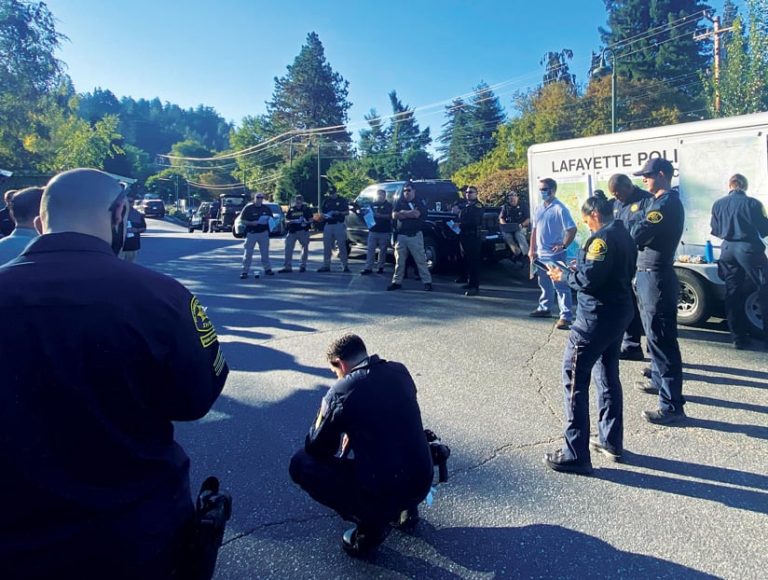 Group of GeoAcuity staff and law enforcement stand in a socially distanced circle