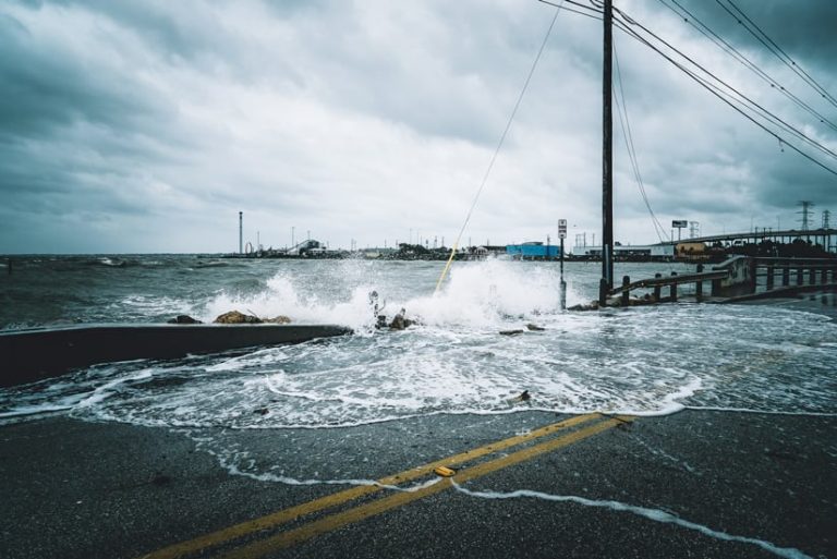 Sea-level rises to the height of a car bridge and breaks the side railing