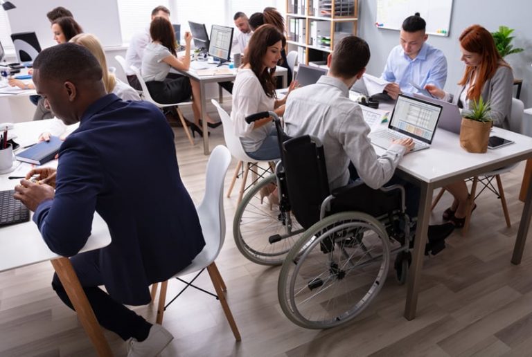 Groups of people sitting at tables working together