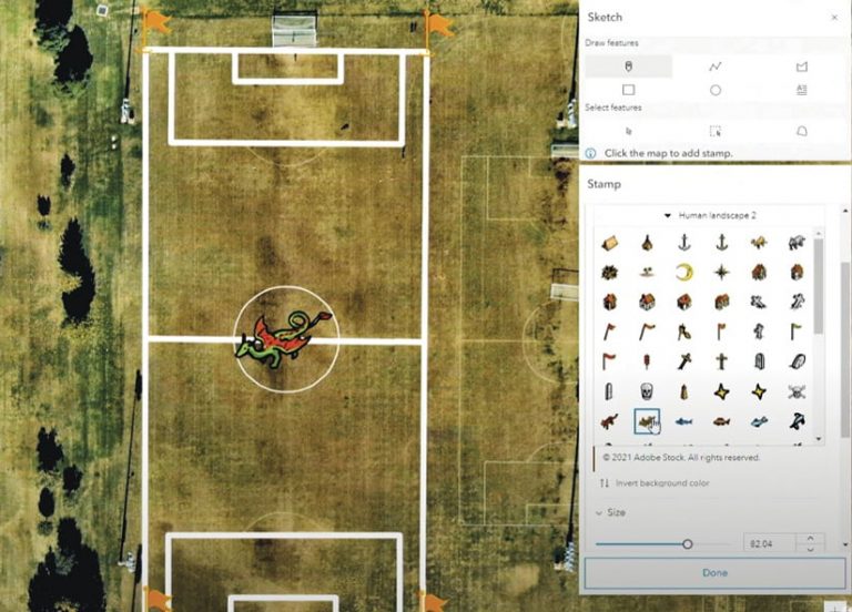 The new Map Viewer’s sketch layer, showing how users can place a stamp—of a dragon, in this example—on imagery of a sports field The new Map Viewer’s sketch layer, showing how users can place a stamp—of a dragon, in this example—on imagery of a sports field