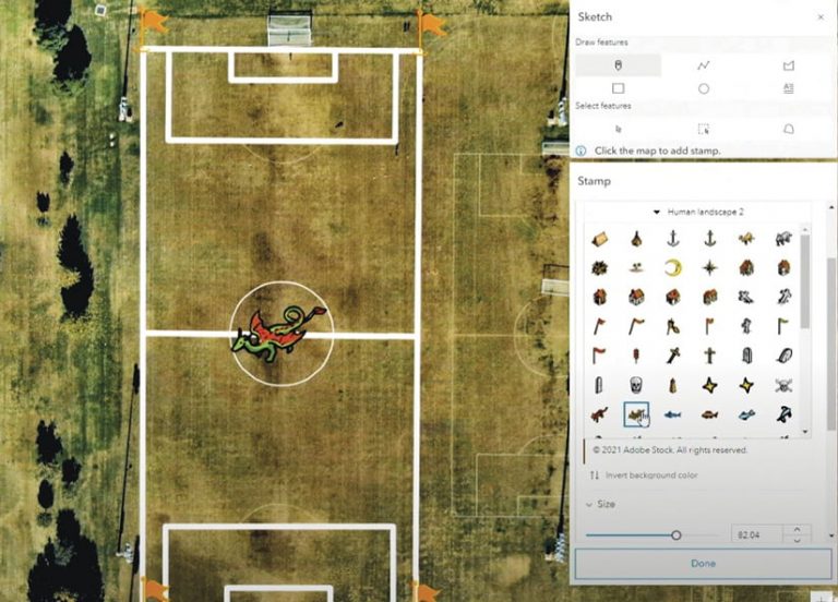 The new Map Viewer’s sketch layer, showing how users can place a stamp—of a dragon, in this example—on imagery of a sports field