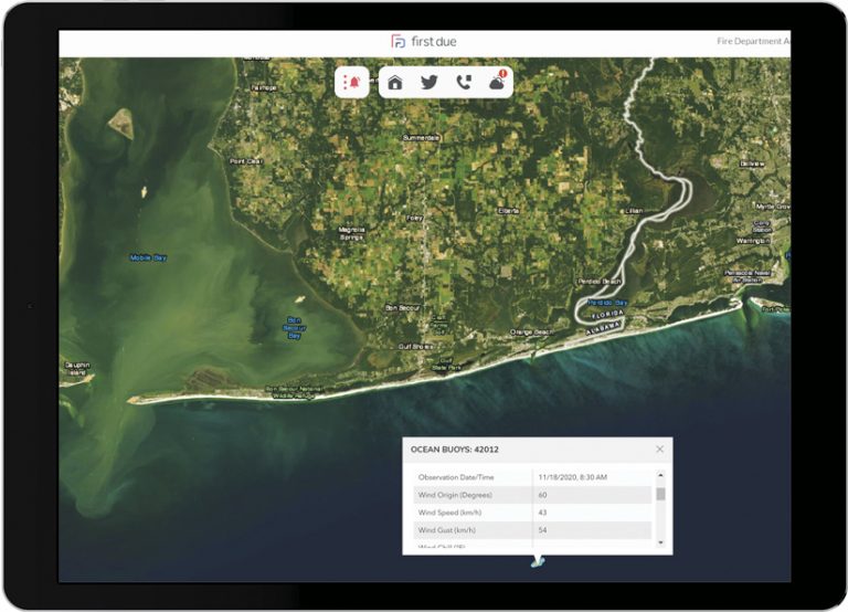 A tablet displaying imagery of Orange Beach, Alabama, in the First Due interface, with a text box popping up from a buoy in the ocean that has information about wind origins, wind speed, and more