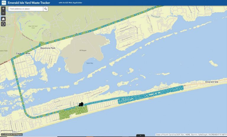 A map showing the tracks of two yard waste trucks—in blue and green—for their pickups along Emerald Isle and their trips to the landfill