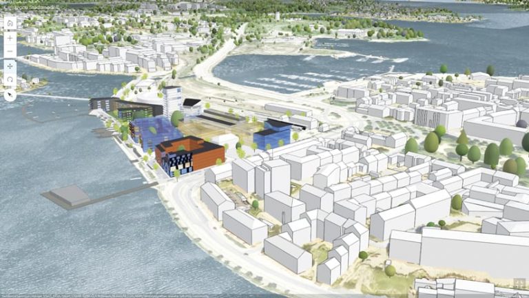 A 3D rendering of a seaside area of Karlskrona, with most buildings shown in white and a cluster of planned buildings shown in blue, gray, black, and orange