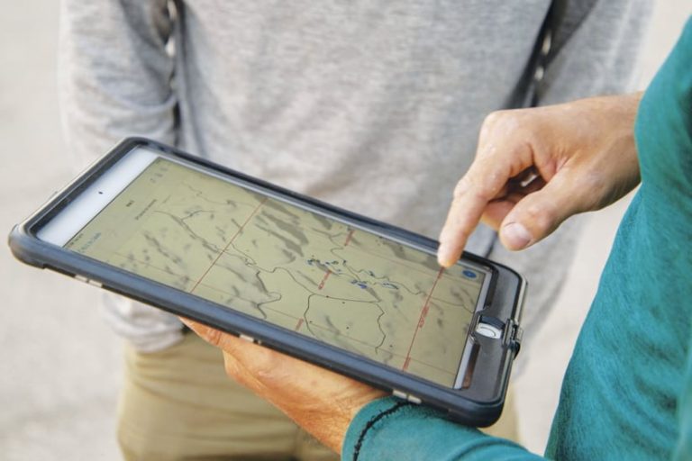 A person using a map on a touchscreen mobile device