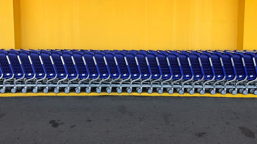A line of shopping carts signifies the retail industry, where in-store technology is booming