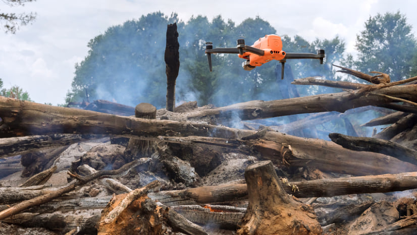 drone hovering above a debris pile