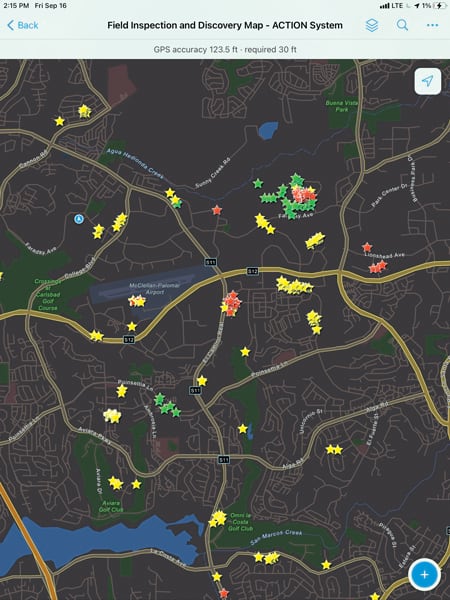 A dark map of Carlsbad with yellow, green, and red stars in various places