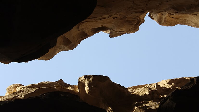 A rocky chasm looking up at sky symbolizes the gender pay gap