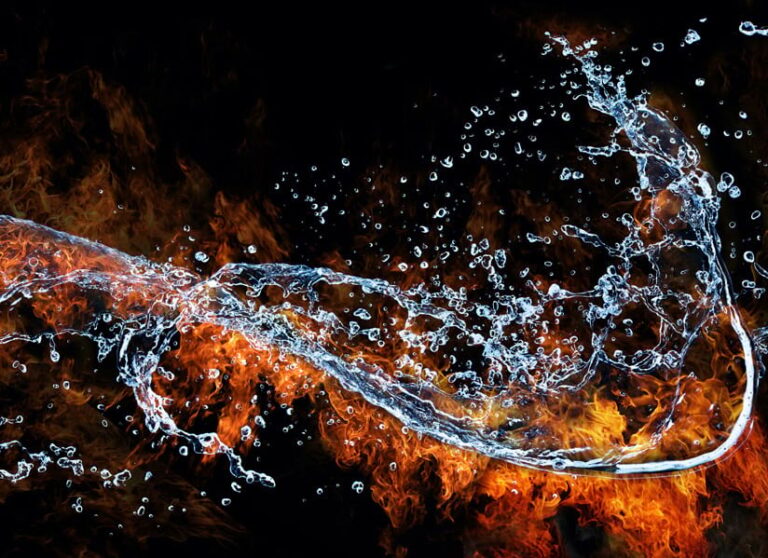 A splash of water brushing up against flames A splash of water brushing up against flames