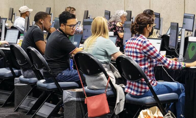 Several people working on computers in a room