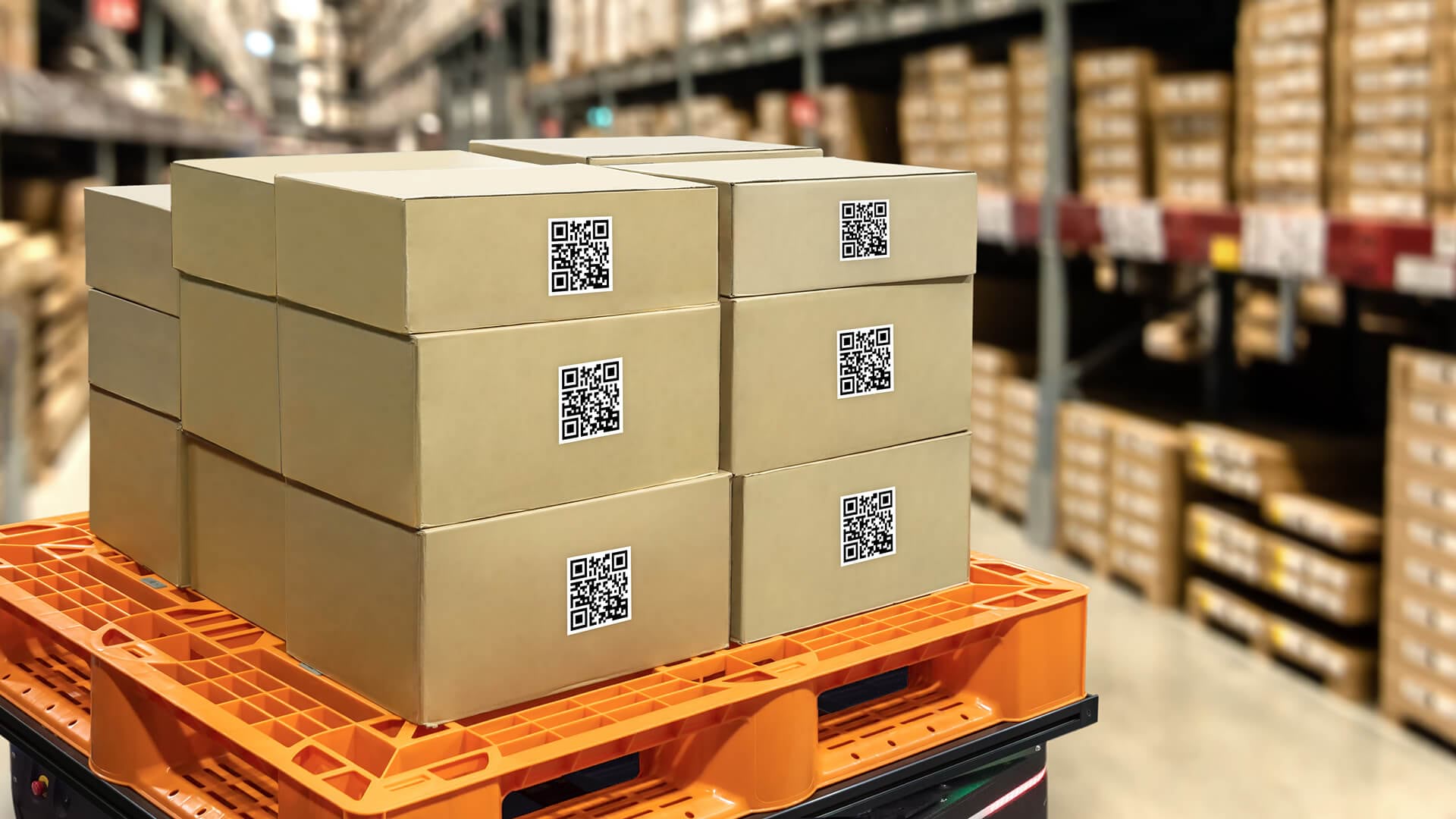 A pallet holding QR-tagged boxes represents supply chain agility