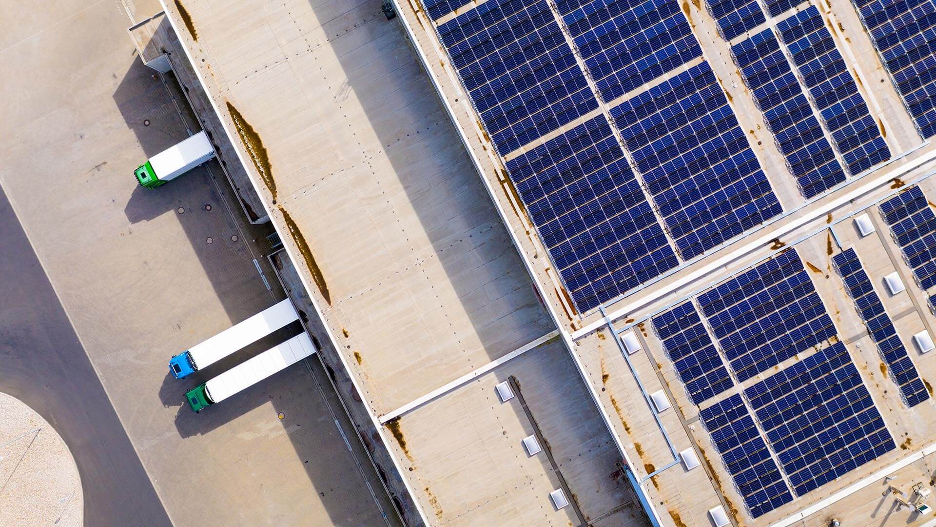 A warehouse rooftop with solar panels in large blocks