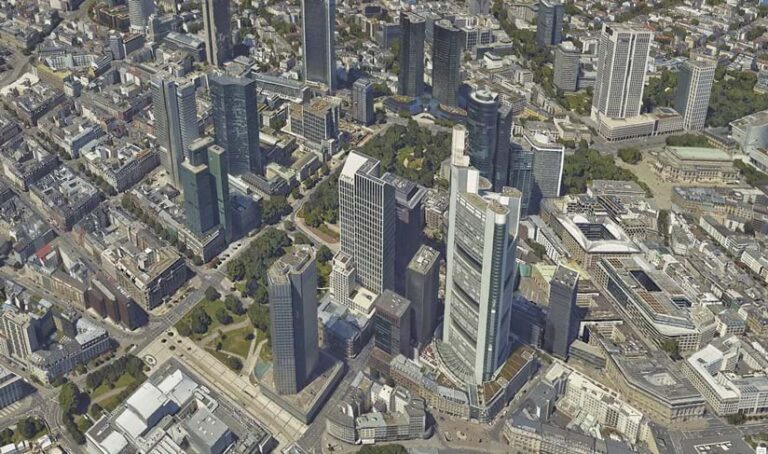 An aerial view of a very realistic-looking 3D rendering of skyscrapers in a city