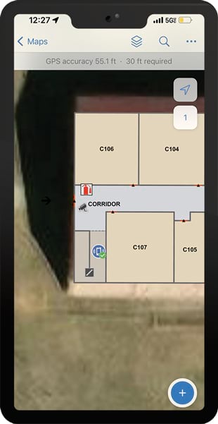 A smartphone screen showing a detailed indoor map that has classrooms, a fire extinguisher, a security camera, and the location where a phone call is being placed on it
