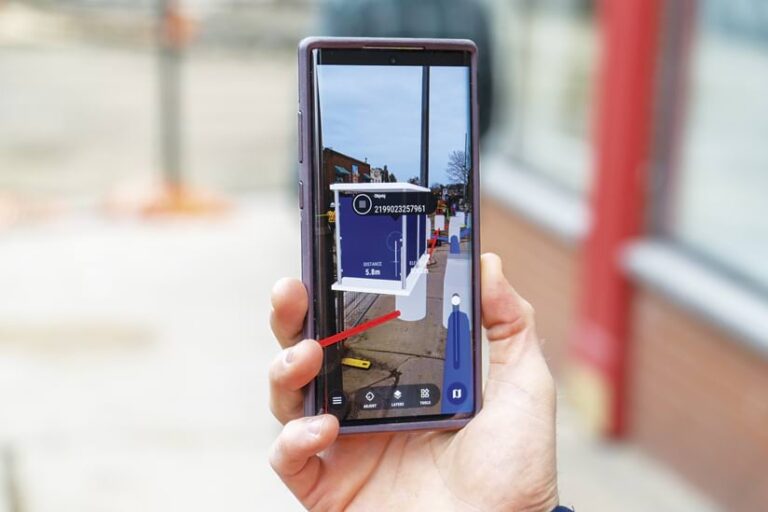 A hand holding up a smartphone with a virtual reality map on it
