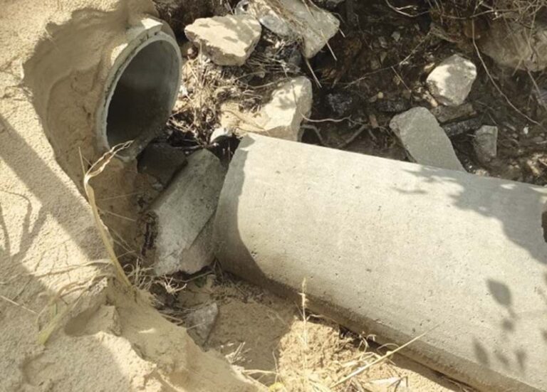A broken pipe with rocks all around it