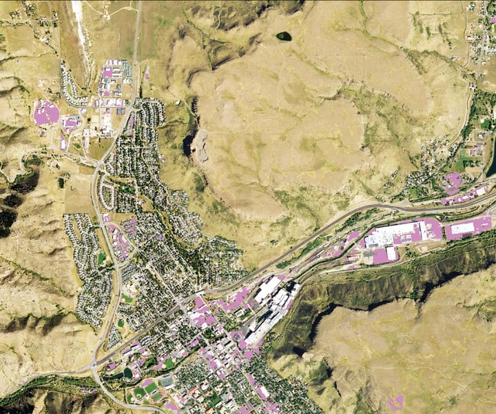 An aerial image of a city with some sections of it shaded in purple