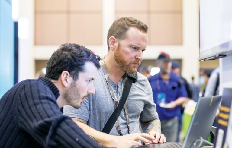 Two people looking at a screen.