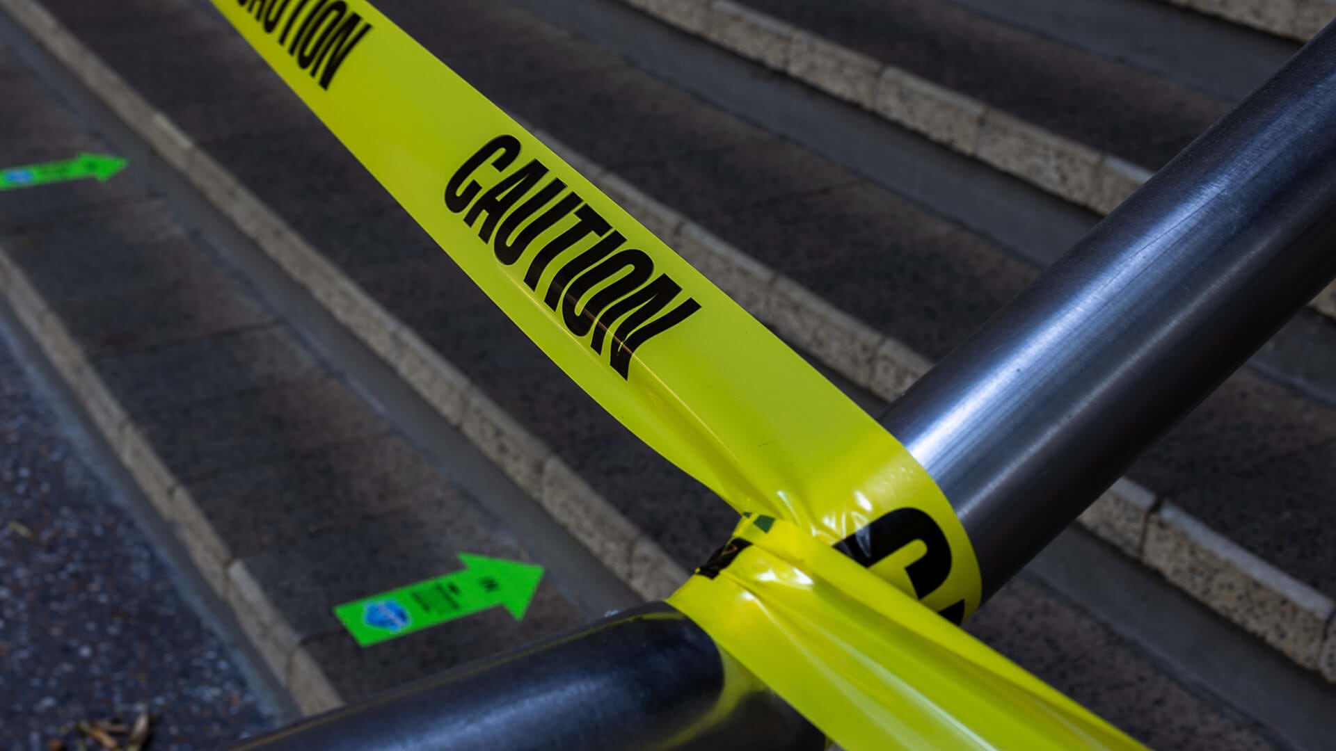 Risk management is symbolized by caution tape over a stairway