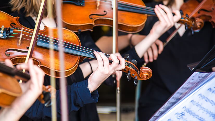 Collaboration symbolized by violins in an orchestra