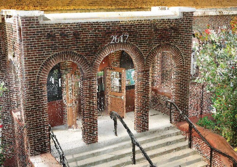 Stairs lead up to a brick building entrance with three arches.