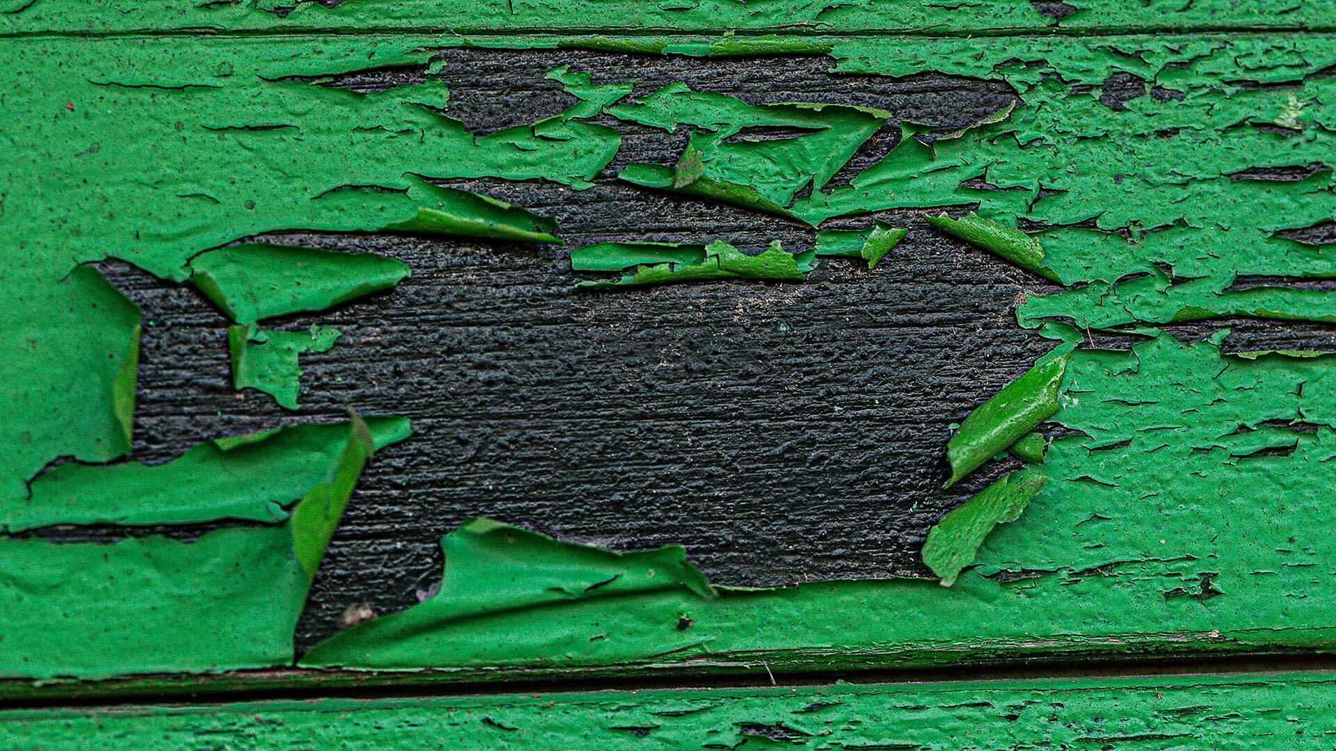Chipping green paint symbolizes the practice of greenwashing
