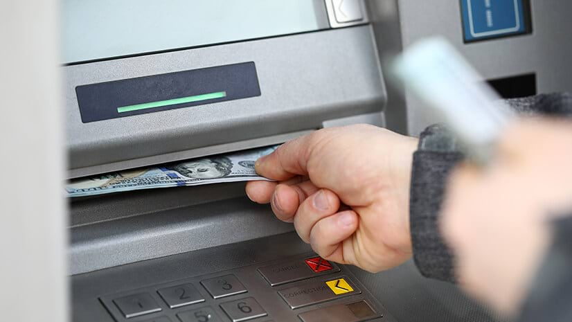 Removing cash from a banking machine
