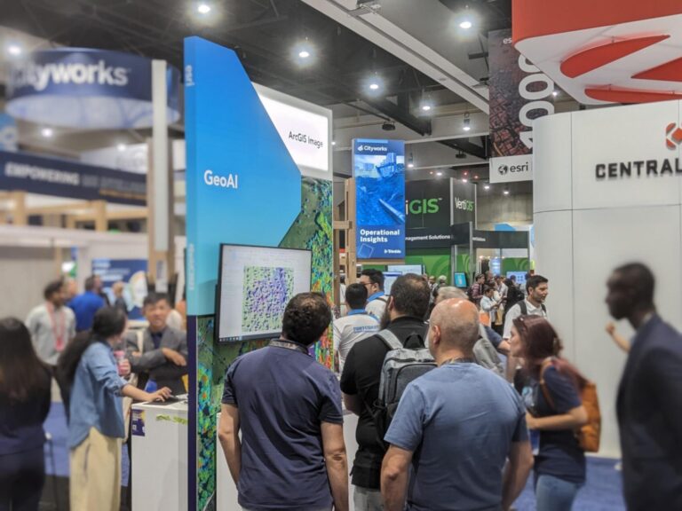 People gathering around a GeoAI kiosk at Esri UC 2023