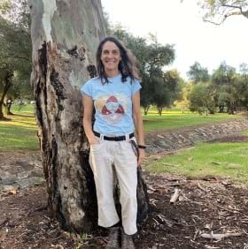 Dr. Sharolyn Anderson, physical scientist, stands next to a tree