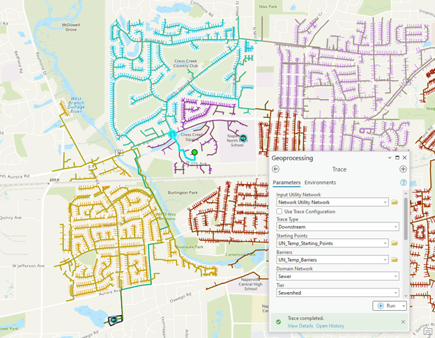 This graphic shows a map in ArcGIS Pro with an open dialog for an upstream trace in the sewershed tier. The map has lines that are color coded for each sewershed with point symbols indicating the location of the treatment plant and pumps. There is a green dot representing the starting location of the trace and all the features between the starting location and the pump are selected.