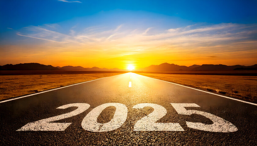Open road leading into a sunset, with the year 2025 inscribed on the pavement.