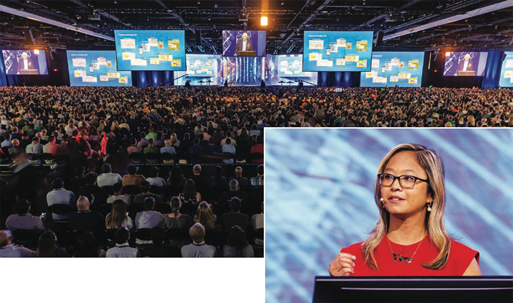 An image of an Esri User Conference plenary speaker overlaid on a wide shot of a full auditorium.