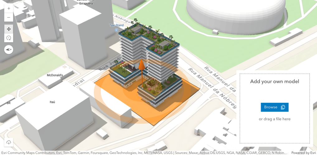 3D building model positioned on a city site in the Editing SceneLayer sample app, with an orange manipulator for moving and refining placement.