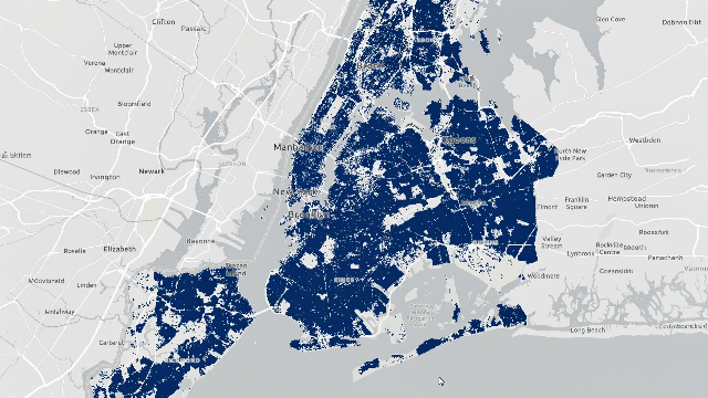 A grayscale map of New York City overlaid with dense dark blue features representing a Parquet feature layer, illustrating high‑performance visualizing of large spatial datasets in the browser.
