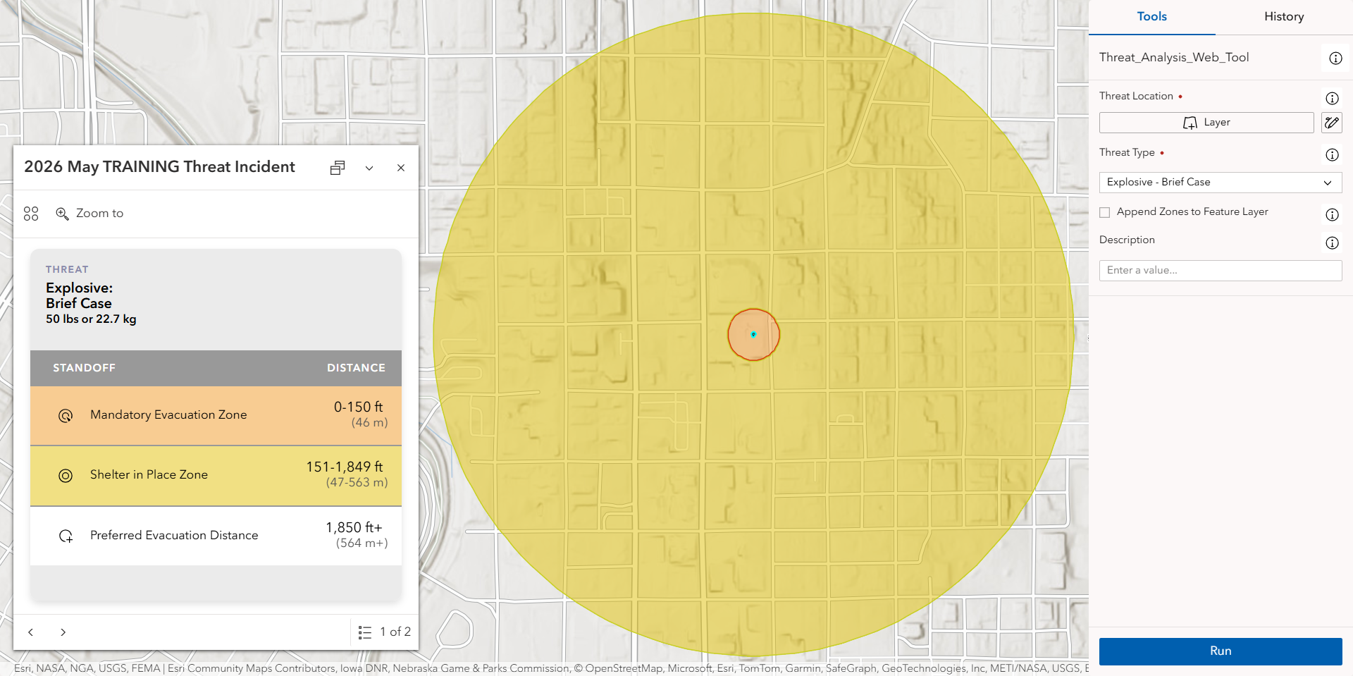 Zones for an explosive threat with a yellow outer buffer and an orange inner buffer.