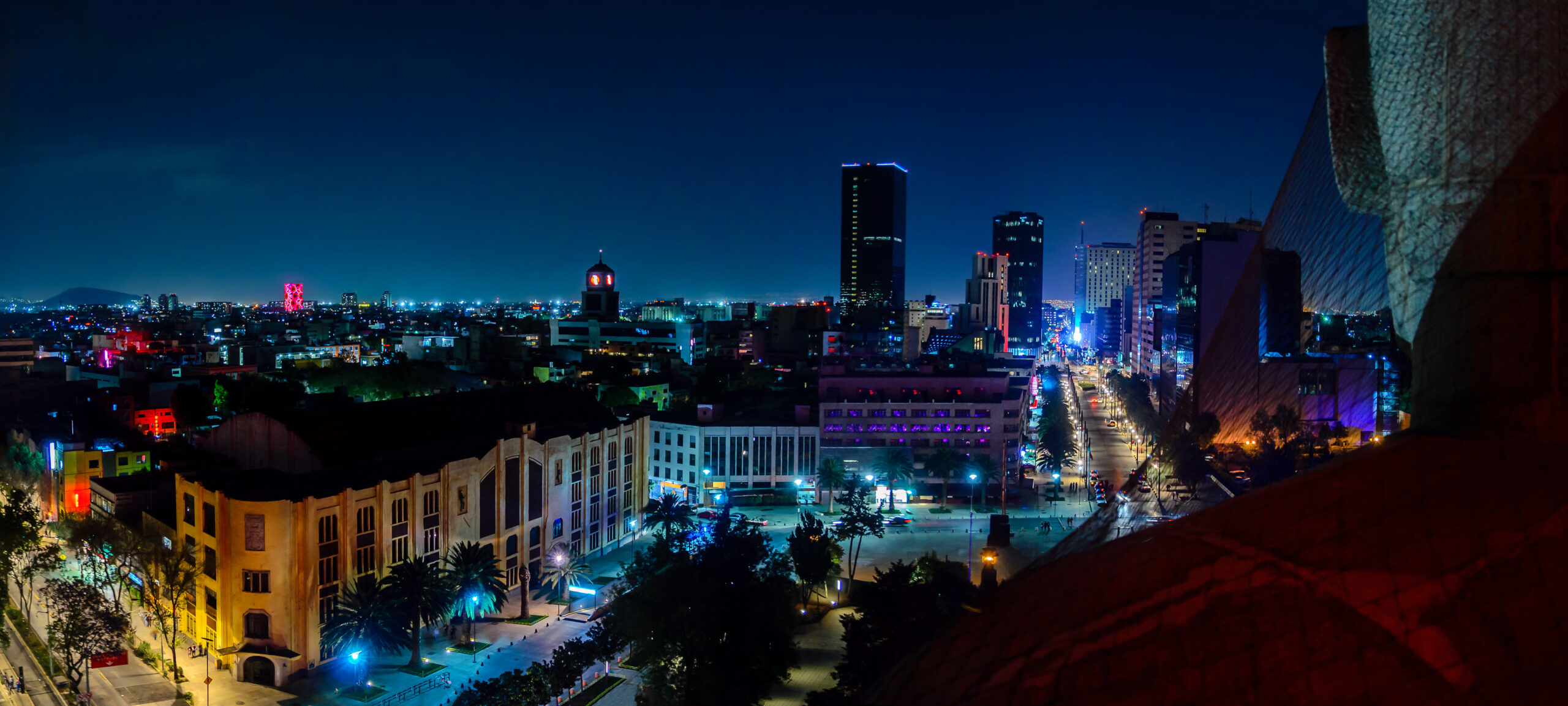 Downtown Mexico City skyline at night from top of the revolution monument.