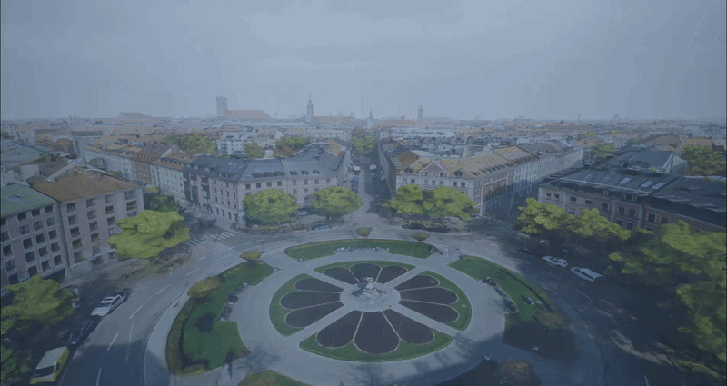 Rendered aerial city scene showing a circular plaza with landscaped gardens, surrounding streets, and buildings, illustrating an urban environment in a 3D digital application.