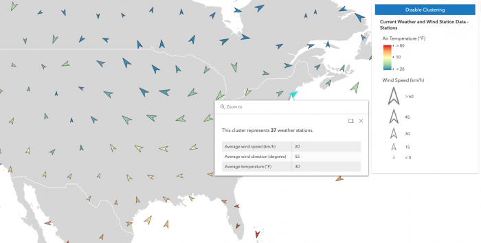 Weather stations in the United States visualized in clusters as arrow markers. Each arrow is colored, sized, and rotated based on three variables: temperature, wind speed, and wind direction. An open popup displays the averages for each of these variables along with the total number of features inside one of the clusters.