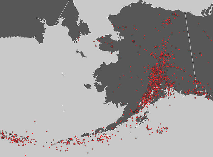 The state of Alaska with earthquakes visualized as red dots.