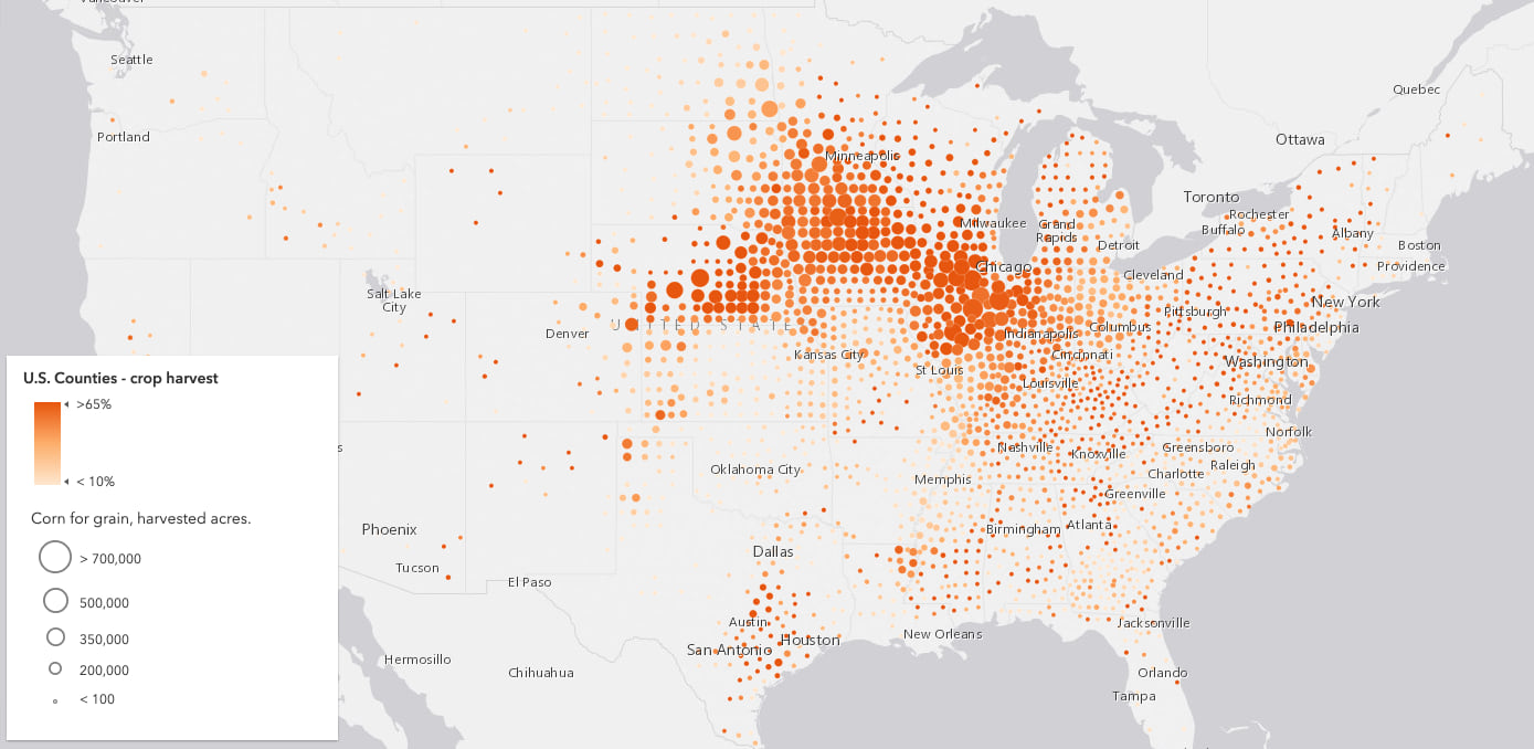 Map of the United States counties colored by the percentage of harvested acres that yielded corn. Each county is colored using the Orange 2 color ramp and given an icon and size based on total corn yield.