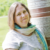 A headshot of Shana Crosson wearing a very nice green and blue scarf