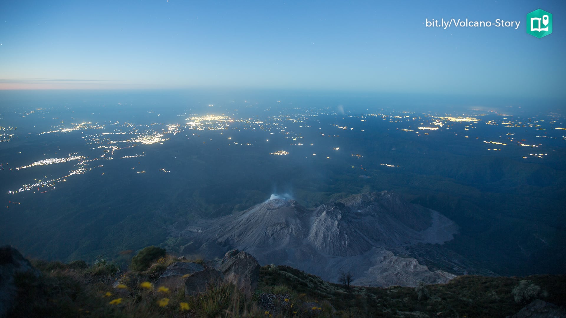 The twinkling lights of communities is visible in the pre-dawn view of Santiaguito volcano in Guatemala.