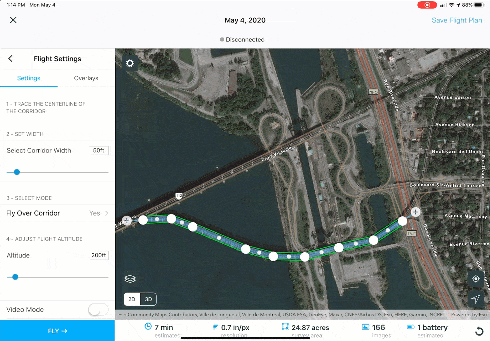 Satellite image of a bridge with markups being drawn to define a flight path.